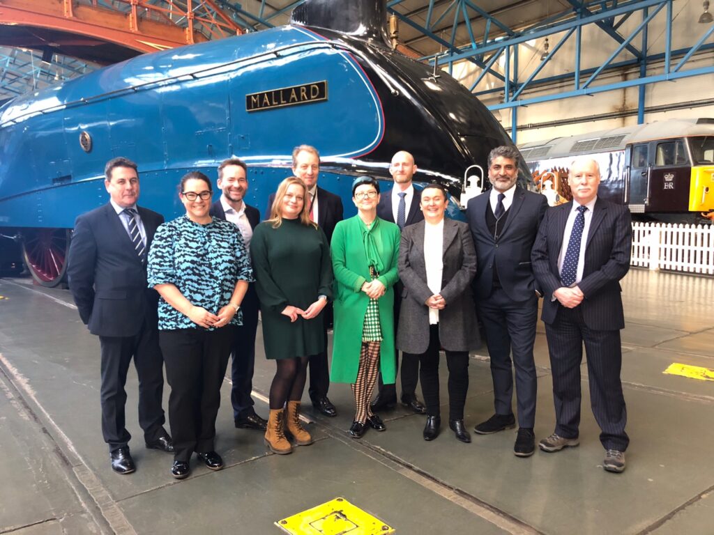 Photo of minister in front of Mallard train